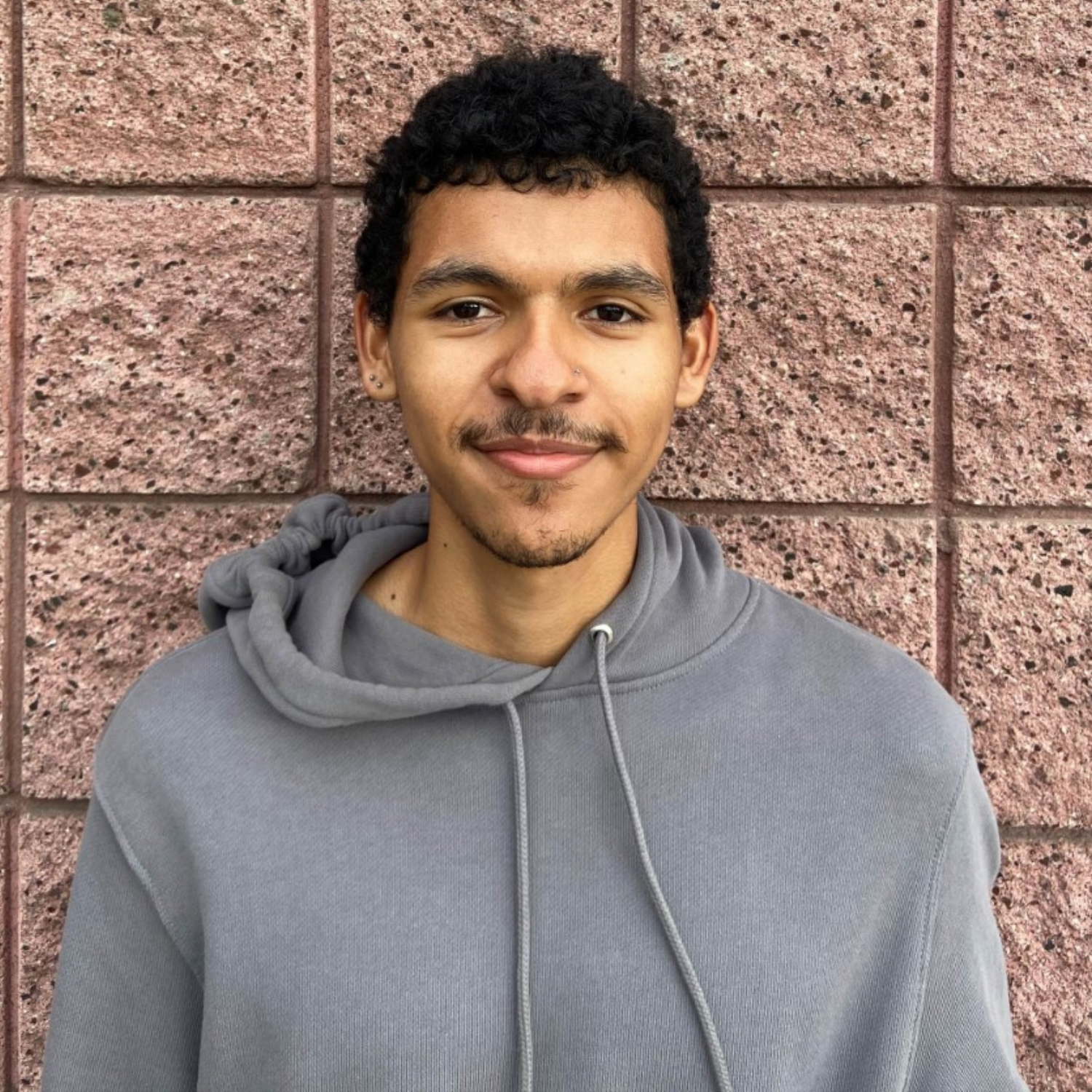 Photo of student Omar in a grey sweatshirt