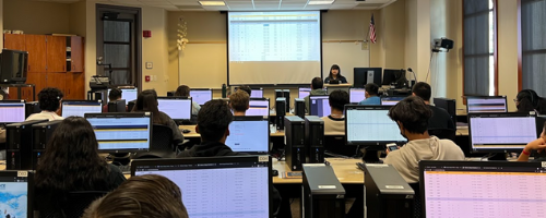Staff hosting a registration workshop in a computer lab