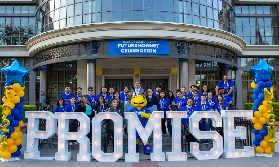 Team EPP Photo of staff behind light up marquee letters that read "PROMISE" in front of the Fullerton College Library.