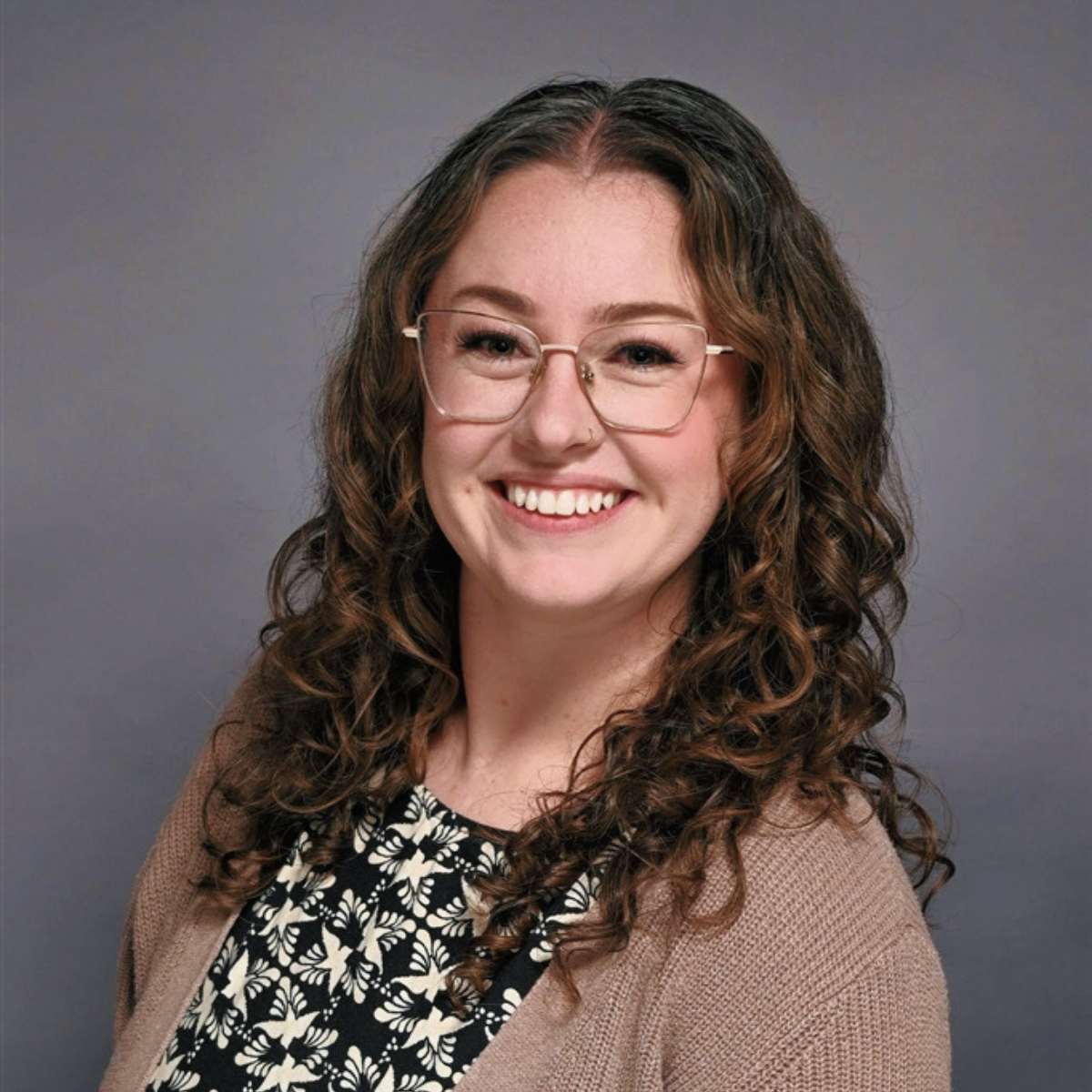 Photo of Annika with a black and white top and brown cardigan. 